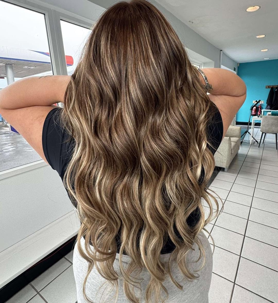 Long brunette balayage with soft caramel waves