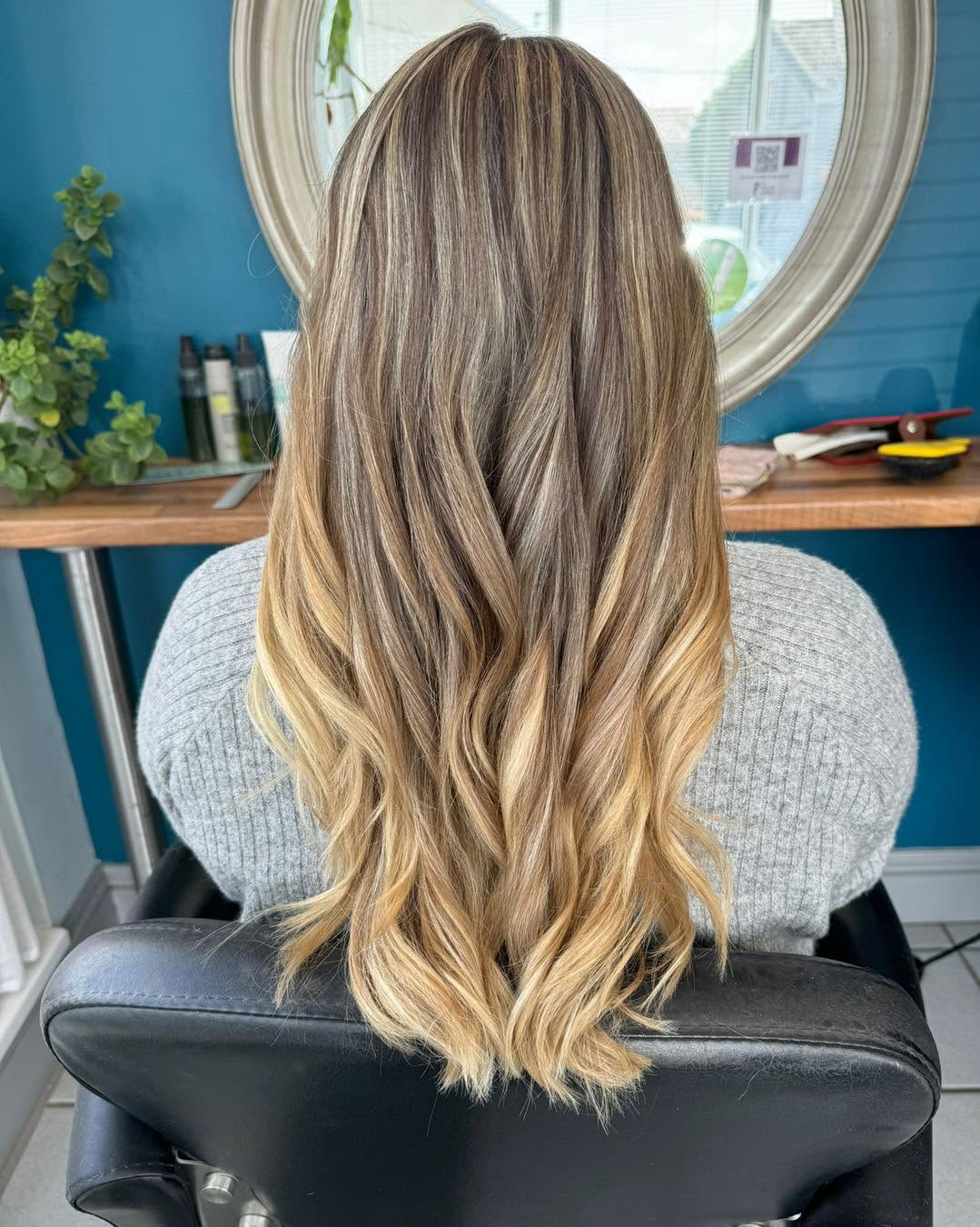 Dark roots melting into warm honey blonde ends